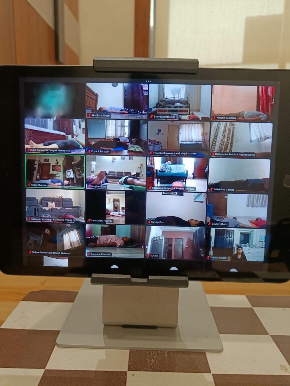 Tablet showing a live Sukh Space online yoga session